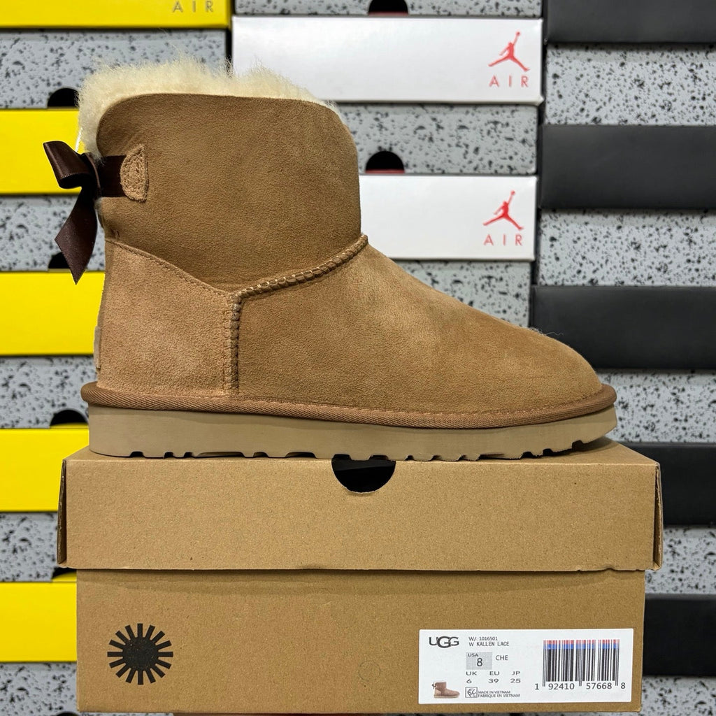 UGG Mini Bailey Bow Ankle Boot – Suede Boot with Cream Shearling Lining, Dark Chocolate Satin Bow & Tan Sugar Sole in Chestnut